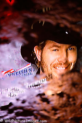 A Toby Keith video sign reflecting in a rain puddle on a sidewalk on the Strip, Las Vegas, Nevada.